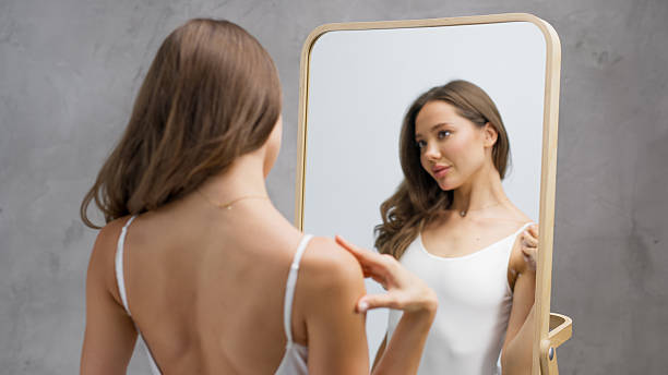 istock Woman applying skincare product on her hands while looking 2231606108