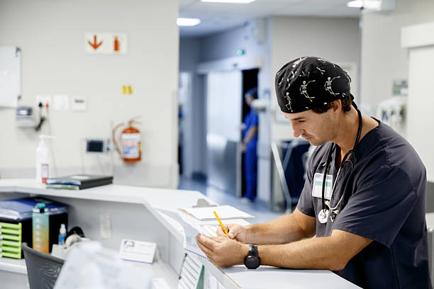 istock Doctor checking documents at Nurse station in a Hospital 2231608322