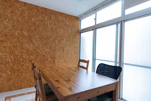 Dark home interior with wood dining table lit by lamp, evening light for dinner. High quality photo