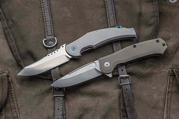 istock Two high-end folding knives on a vintage canvas and leather bag. 2231611217