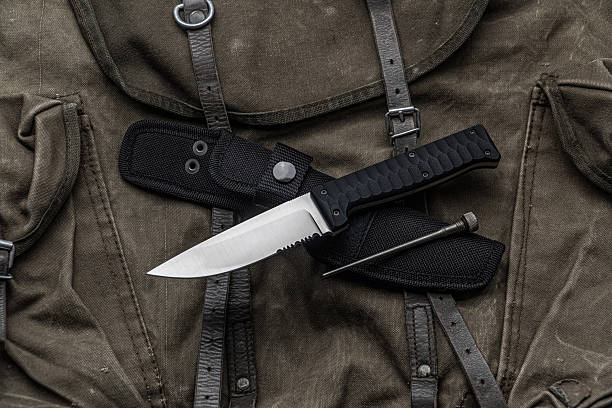 istock Two high-end folding knives on a vintage canvas and leather bag. 2231611232