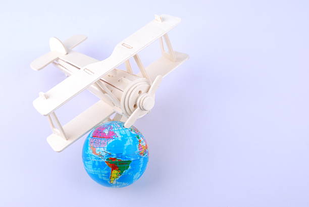 Model of an airplane flying over the globe