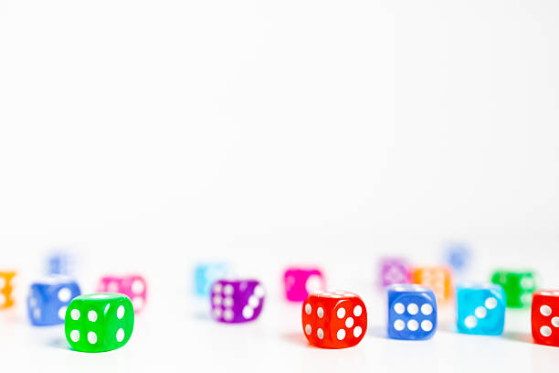 istock Colorful dice scattered on white surface for board games and entertainment 2231617302