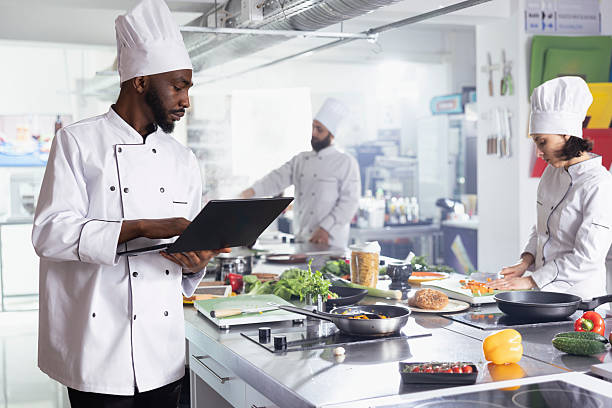 istock African american chef in a modern kitchen using laptop to discover new dishes 2231618031