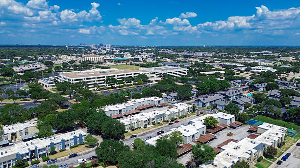 istock Blending of low rise flat roofed apartment complexes, multilevel parking structure from corporate campus, office buildings, major highways, and distant skyline background in Richardson, Texas 2231619920