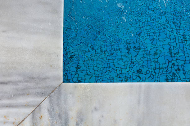 istock Marble edge and pool water with ripple reflections 2231620866