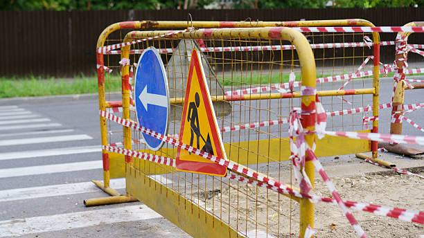 istock Construction barriers block road near intersection during day to ensure safety for pedestrians and vehicles in urban area 2231623168