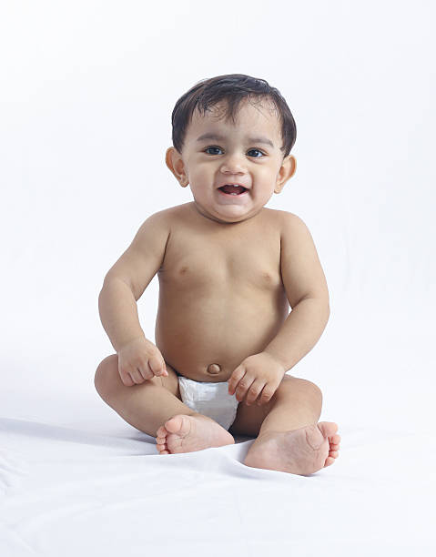istock Baby boy sitting upright with hands on knees in studio. 2231623502