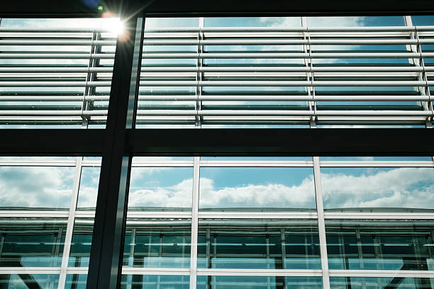 istock Modern symmetry architecture design with sunlight, glass facade, steel frame and reflective window in the airport 2231624911