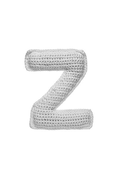 istock Handmade crocheted letter Z in light grey yarn, isolated on white background, soft textured decoration or toy 2231626543