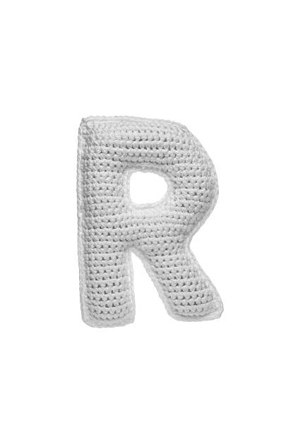 istock Handmade crocheted letter R in light grey yarn, isolated on white background, soft textured decoration or toy 2231626561