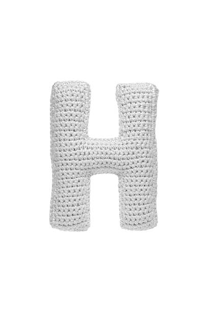 istock Handmade crocheted letter h in light grey yarn, isolated on white background, soft textured decoration or toy 2231626594
