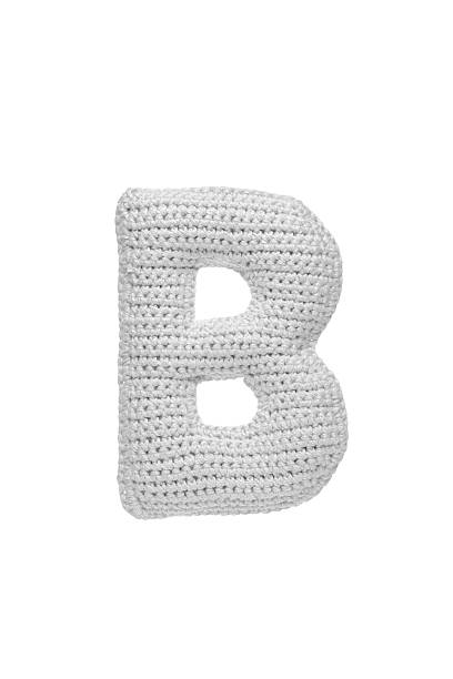 istock Handmade crocheted letter b  in light grey yarn, isolated on white background, soft textured decoration or toy 2231626608