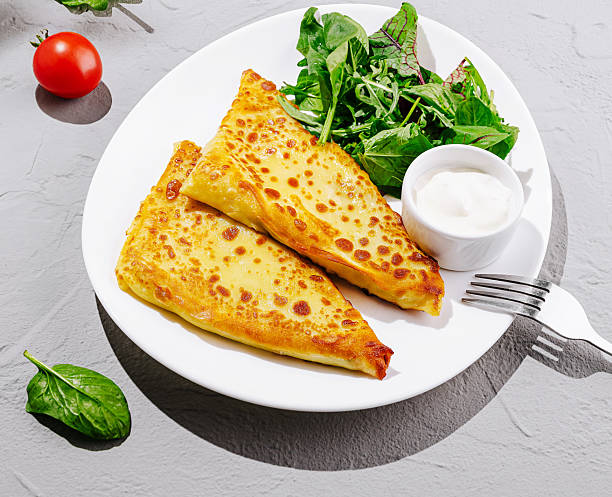 istock Savory stuffed pancakes served with fresh salad and dipping sauce 2231628297