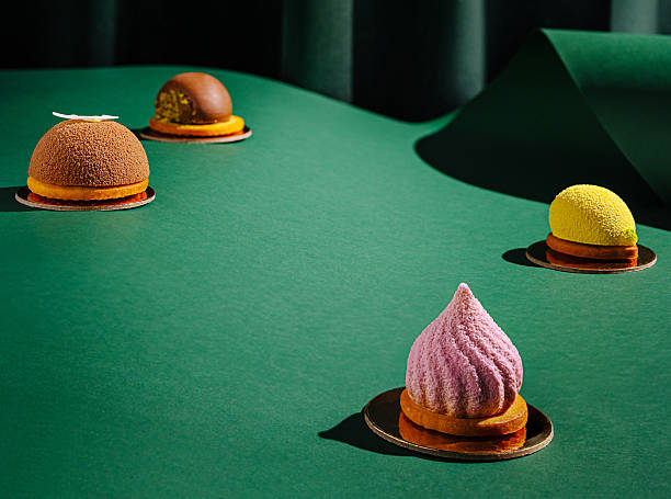 istock Desserts displayed on a green surface with elegant fabric backdrop 2231628659