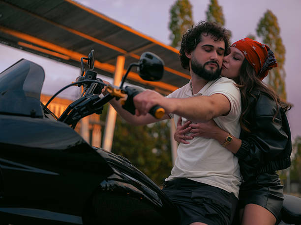 istock Young Biker Couple on Motorcycle Embracing 2231630672