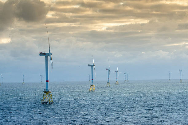 istock Sunset over offshore wind farm - green power generation 2231630675