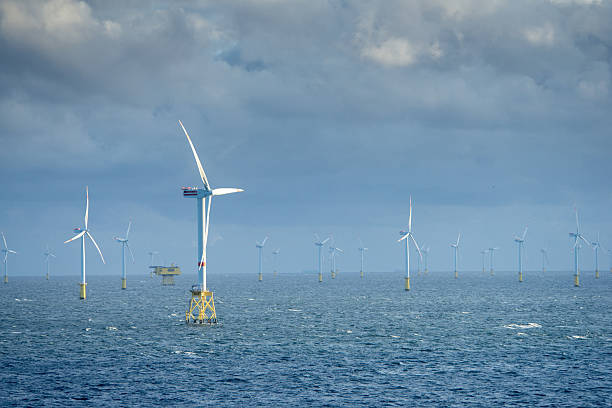 istock Sunset over offshore wind farm - green power generation 2231630732