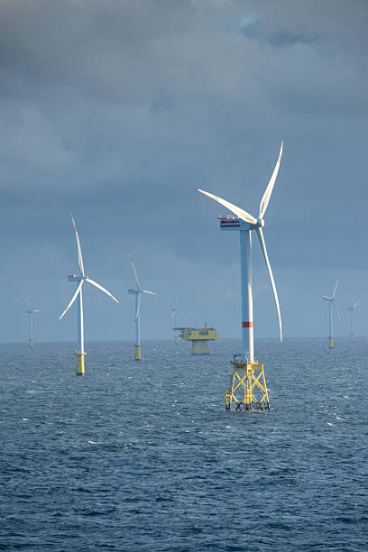 istock Sunset over offshore wind farm - green power generation 2231630756