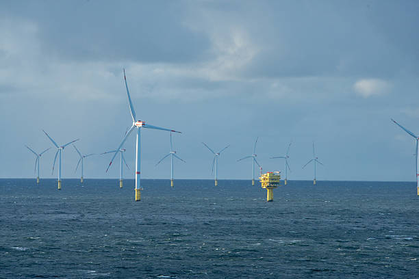 istock Sunset over offshore wind farm - green power generation 2231630899
