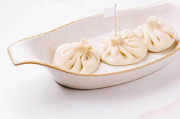 istock Dumplings or khinkali served elegantly on a white dish at a culinary event 2231632944