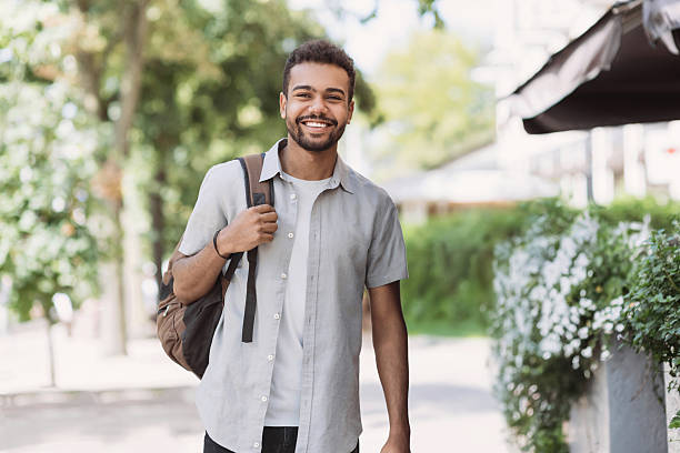 istock Handsome smiling young man in a city 2231634039
