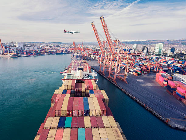 istock Airplane flying over container ship. Transportation concept. Airplane and Container ship. International Port. 2231634316