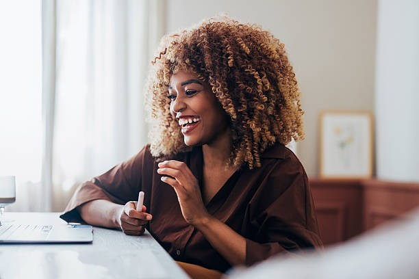 istock Smiling Professional Woman Engaged in Remote Work at a Bright Home Office 2231641614
