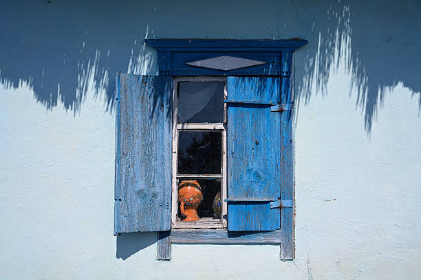 istock Rustic Blue Wooden Window with Shutters and Clay Pot  Horizontal 2231642360