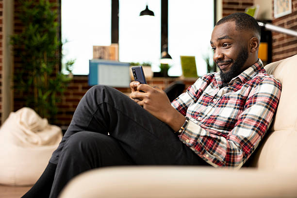 istock Black businessman reading text messages on phone 2231643461
