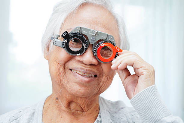 istock Optometrist checking Asian elderly woman ophthalmic vision eye test and using optical trial frame. 2231644139