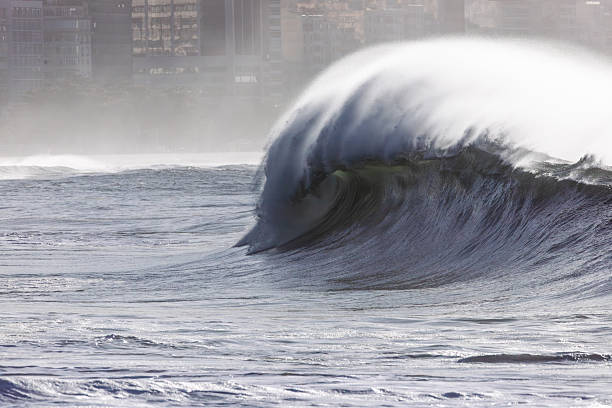 Surfer surfing hollow crashing wave curl a water swimming action photo perspective view of tube ride over shallow reef