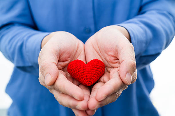 Woman hands holding a heart shape