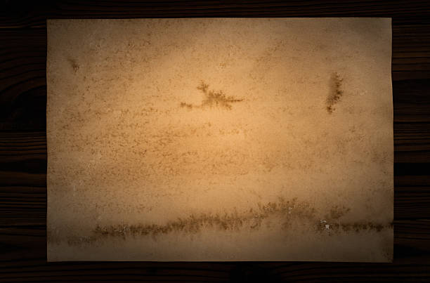 Old boat wooden board over one hundred years. Weathered and scratched rustic wooden board. High angle view of a flat textured wooden board backgrounds. It has a beautiful nature and abstractive pattern. A close-up studio shooting shows details and lots of wood grain on the wood table. The piece of wood at the surface of the table also appears rich wooden material on it. The wood is dark brown color with darker brown lines and pattern on the bottom. Flat lay style. Its high-resolution textured quality.The close-up gives a direct view on the table, showing cracks and knotholes in the wood.