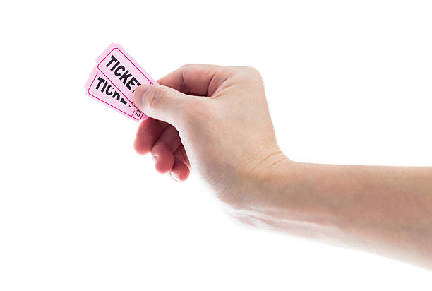istock Hand holding two pink cinema tickets on white background 2231648796