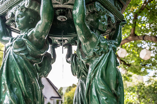 Water fountain for horses with statues of angels holding the structure