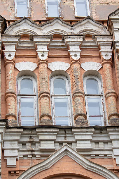 istock Facade of the old building with columns and arched windows 2231651299