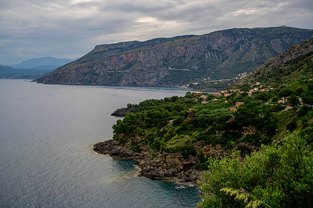 Experience the serene beauty of Playa Peñón Beach in Malaga, Spain. This empty seaside paradise offers stunning views of clear waters, majestic rocks, and a pristine shoreline under a bright blue sky. Perfect for relaxation and nature appreciation.