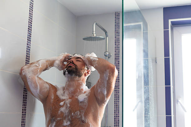 istock Young muscular man taking a shower 2231655756