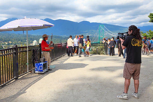 People eating food at outdoor dining area at Granville Island Public Market in Vancouver, Canada