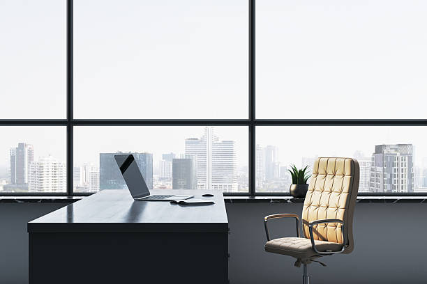 Modern executive office interior with elegant desk and leather chair by large window overlooking cityscape in corporate business setting. 3D Rendering