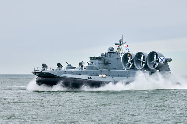 istock Hovercraft warship armed with armament sails into sea toward military target to attack and destroy 2231658557