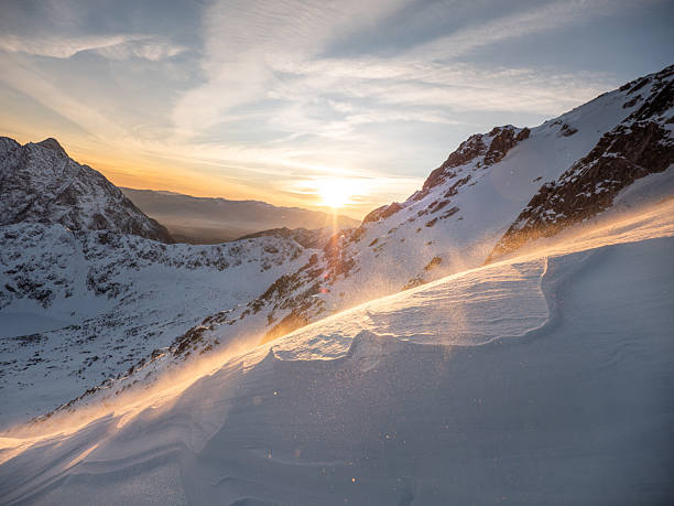 istock The sun setting behind a mountain in a blizzard. 2231659599