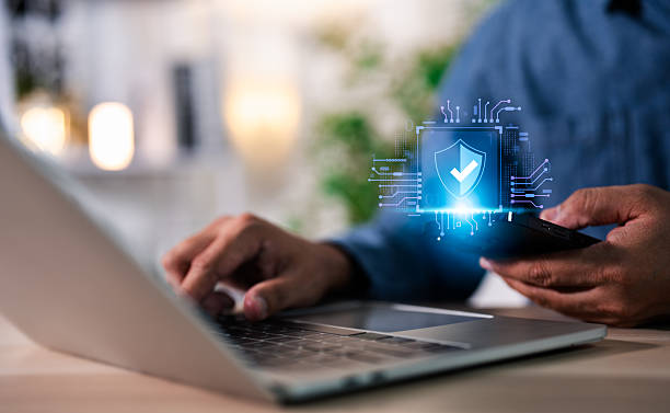 istock Hand of a man using mobile phone and laptop, secure access to user personal information, secure Internet access, information security encryption. Cybersecurity internet network data privacy concepts. 2231659752