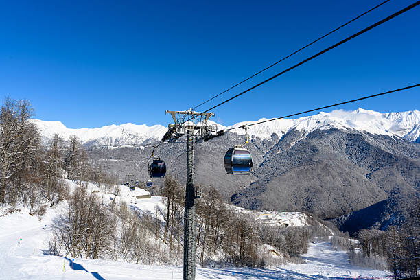 istock Cable car cabins against snowy mountains and clear skies 2231663920