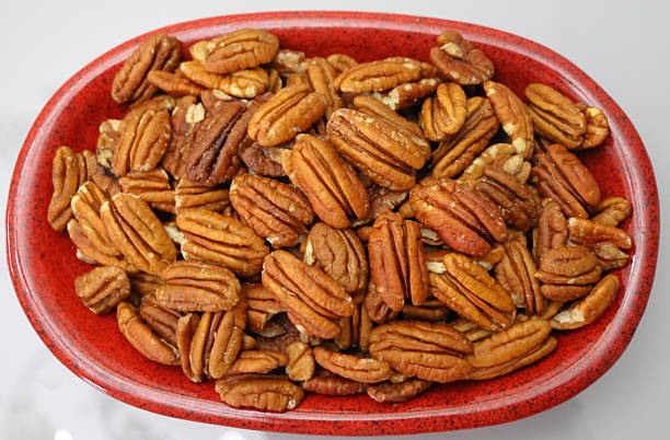 istock bowl of pecan nut and almonds 2231665401