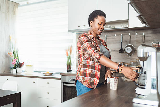 istock Young woman making coffee in her kitchen 2231666438