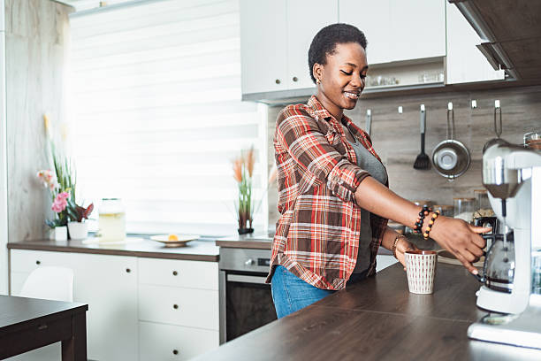 istock Young woman preparing coffee in her modern kitchen 2231666579
