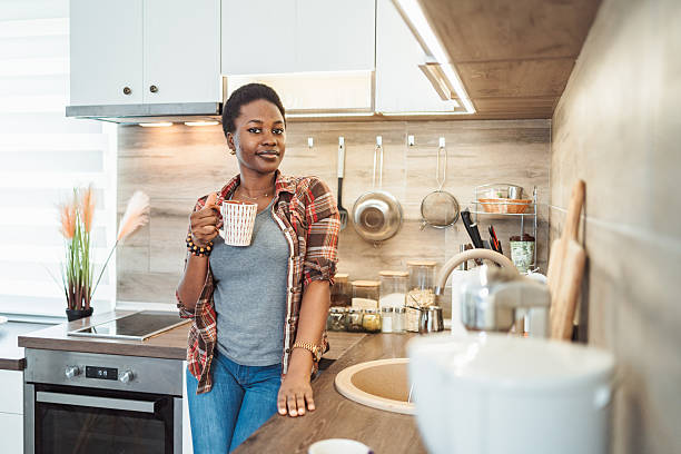istock Young woman drinking coffee in modern kitchen 2231666631