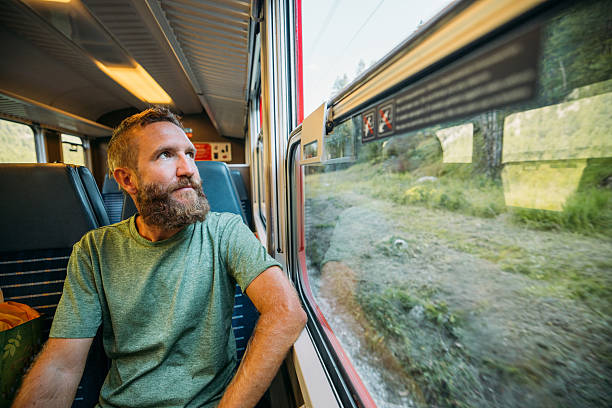istock Bearded Man Relaxing on Scenic Train Ride 2231667693